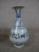 Chinese blue and white porcelain pear shaped vase, decorated with flowers and leaves, raised on