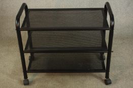A contemporary three tier black painted metal trolley raised on wheels. H.85 W.75 D.40cm.