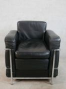 A contemporary Le Corbusier black leather and chrome plated chair, raised on tubular supports.