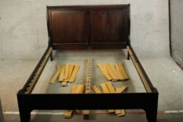 A contemporary stained mahogany double bed. H.101 W.145 D.210cm.
