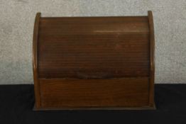 An early 20th century oak dome topped roll top letter rack, opening to reveal fitted interior. H.