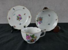 A 20th century Herend cup, saucer and cake plate, decorated with sprays of flowers. H.1 W.17 D.