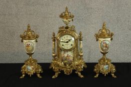 A 20th century gilt brass and porcelain three piece clock garniture, the painted dial with black