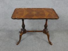 A 20th century Maple Products veneered table raised on turned supports each raised on two splayed