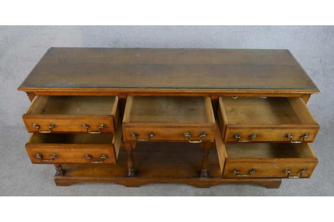 A 20th century oak five drawer sideboard with brass swing handles, raised on turned support with - Image 5 of 8