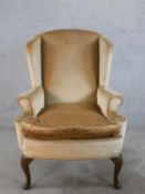 A 19th century mahogany framed chair, upholstered in brown Dralon fabric, raised on cabriole