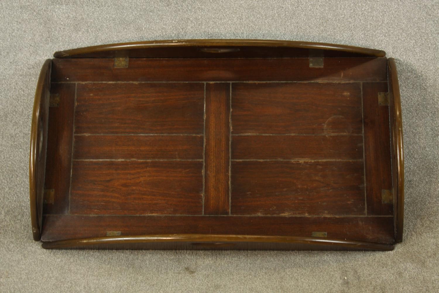 An early 20th century stained mahogany twin handled butlers tray with folding sides. (No stand). L.