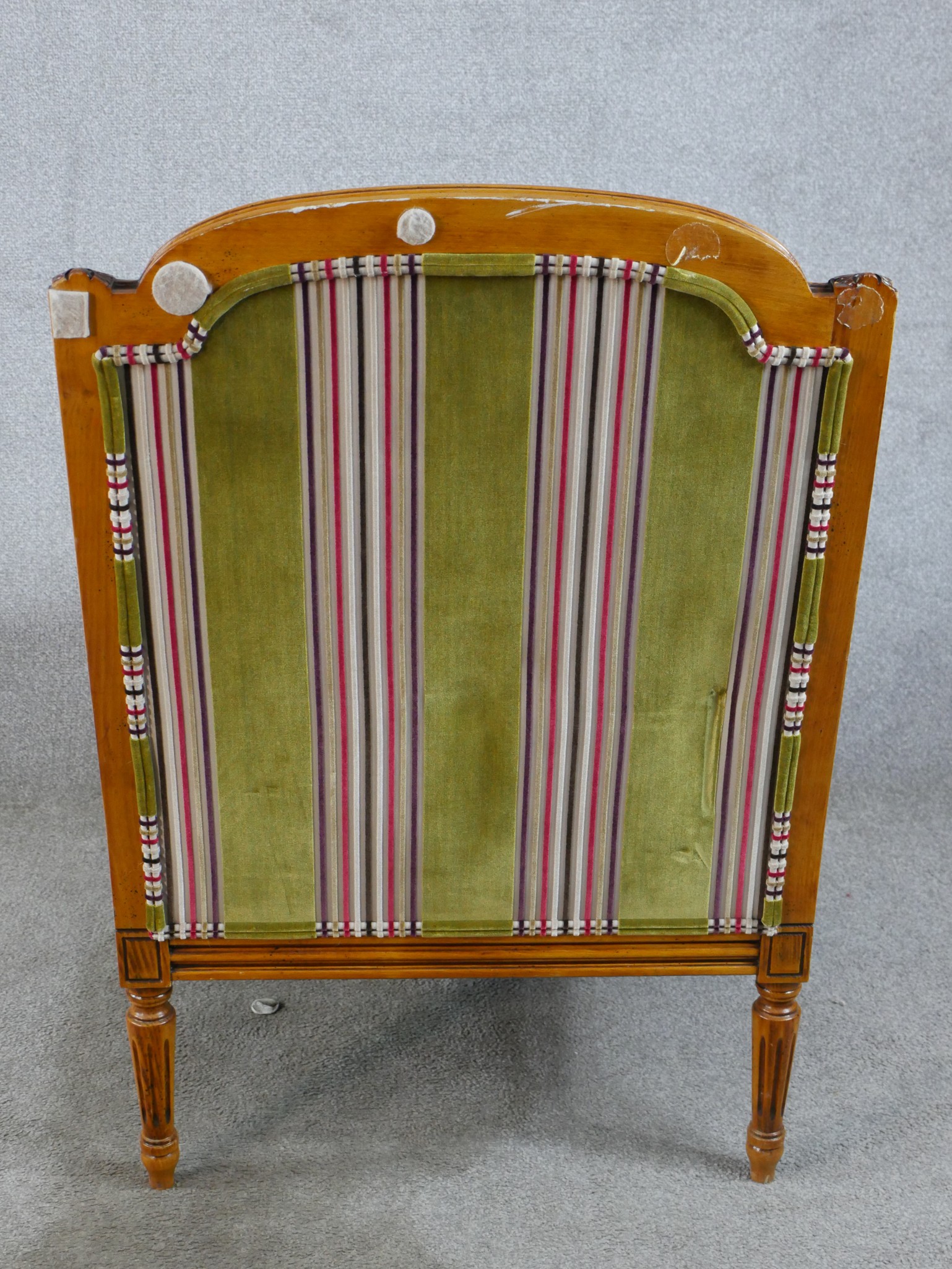A late 19th/early 20th century walnut and bergère framed French style armchair raised on fluted - Image 5 of 5