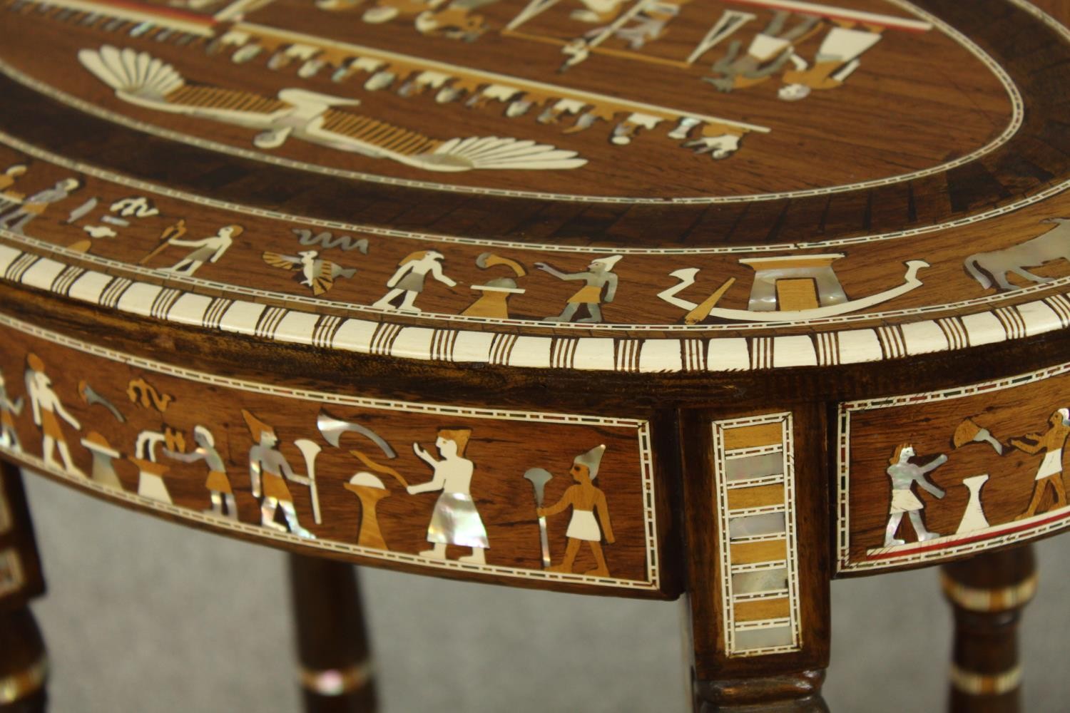 An early 20th century Egyptian Revival mahogany and ebony inlaid oval two tier side table raised - Image 7 of 8
