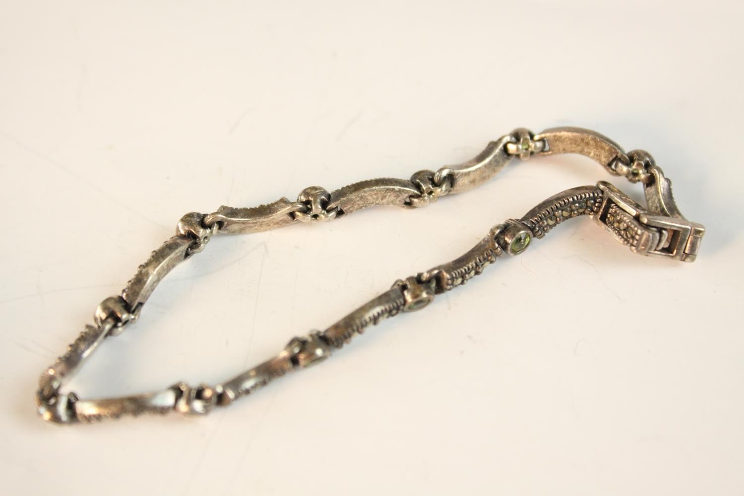 A collection of white metal and Danish silver brooches along with a peridot and marcasite set silver - Image 8 of 8