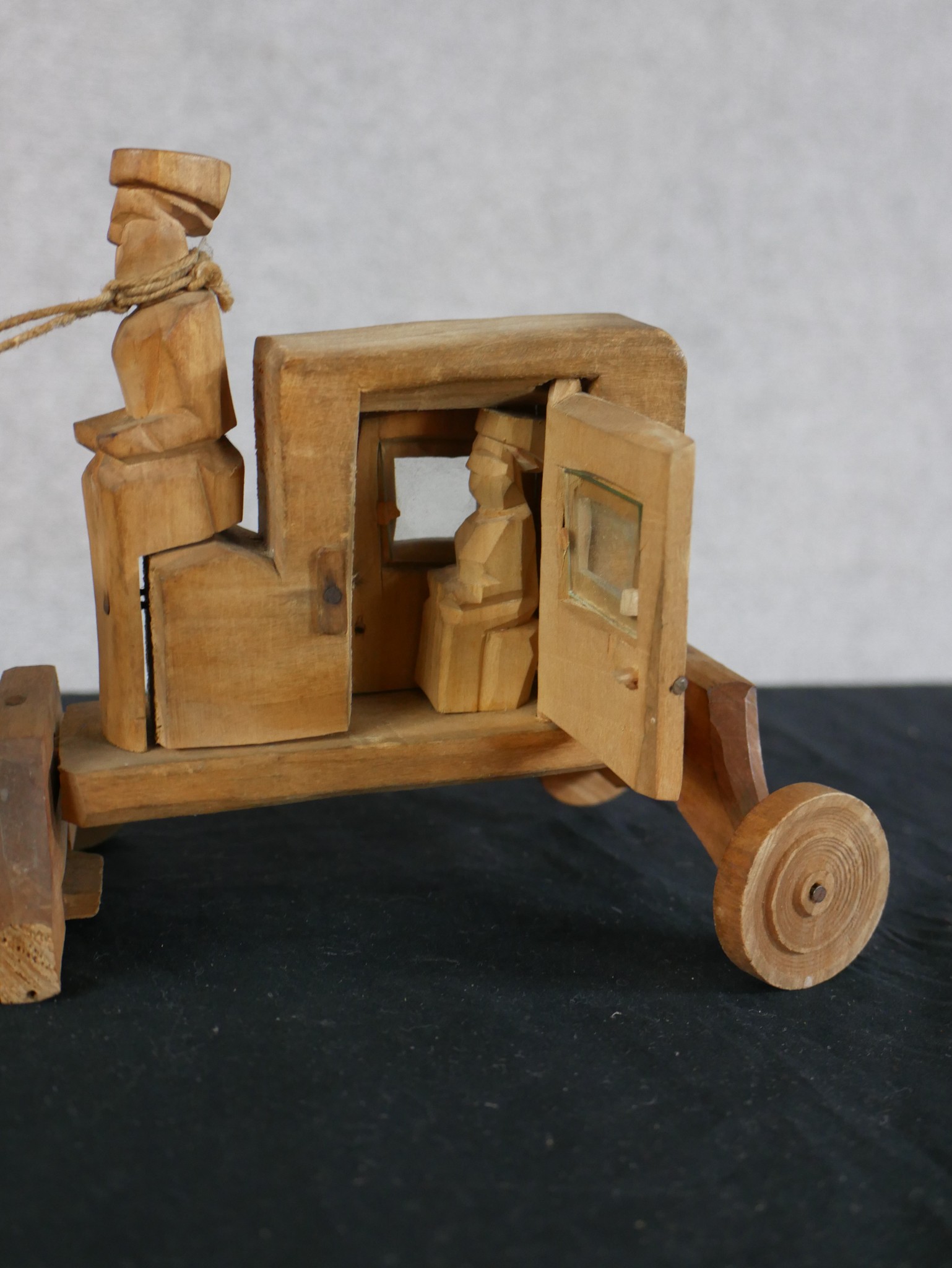 A 20th century carved hardwood toy in the form of a horse being pulling a coach, raised on wheels. - Image 3 of 4