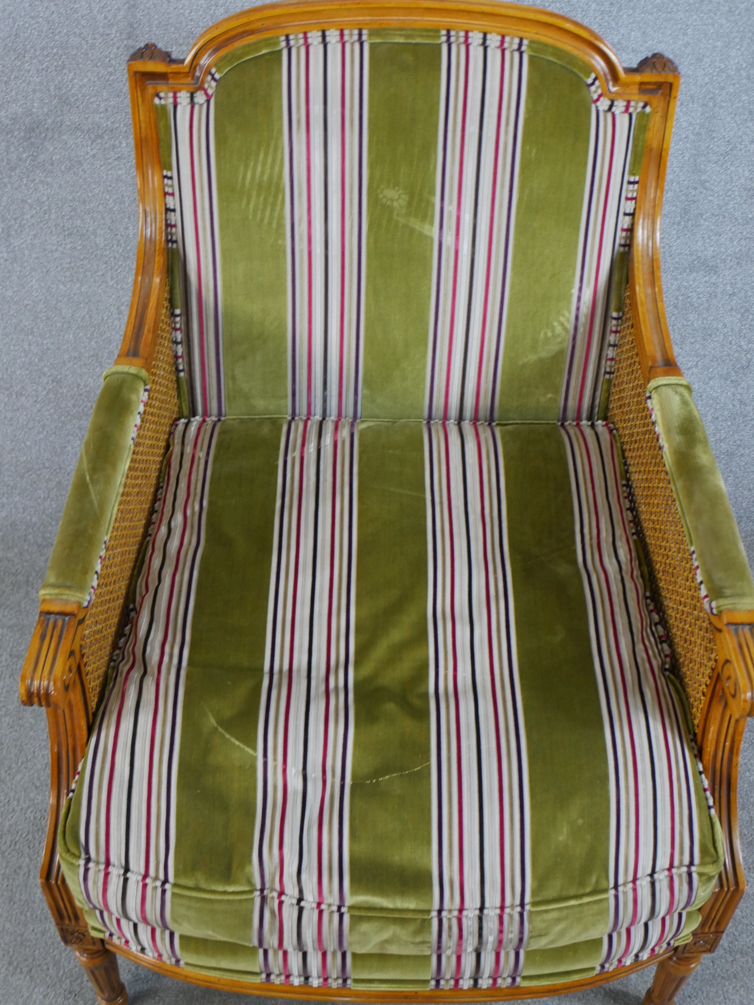 A late 19th/early 20th century walnut and bergère framed French style armchair raised on fluted - Image 2 of 5
