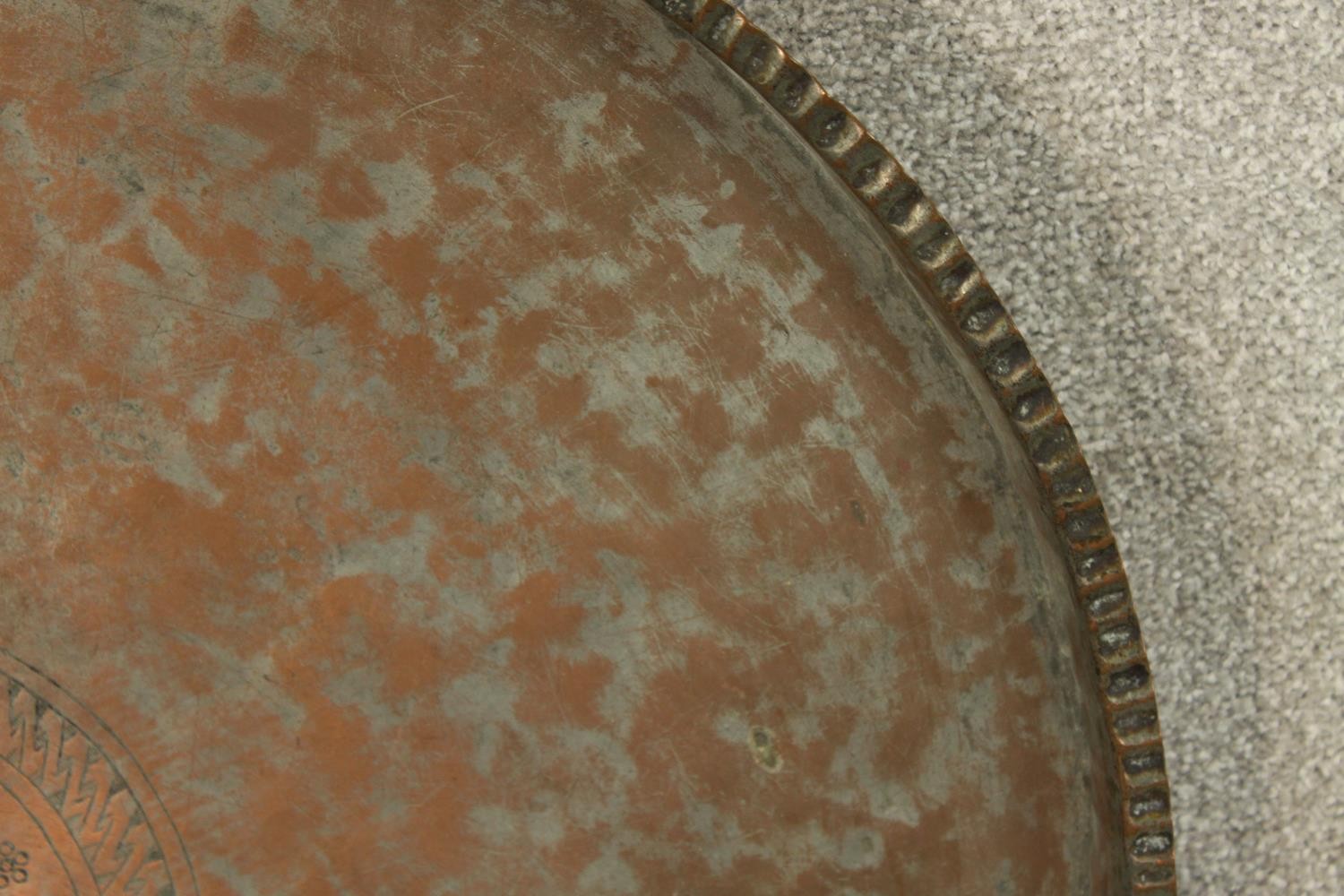 A late 19th/early 20th century engraved circular copper tray. Dia.65cm. - Image 4 of 5