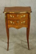 An early 20th century Kingswood and gilt metal mounted serpentine fronted two drawer cabinet, raised