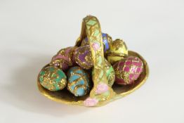 A 20th century painted and richly guilt porcelain Summertime Egg Basket together with nine