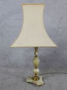 An early 20th century onyx and gilt metal mounted table standing on triform base terminating in