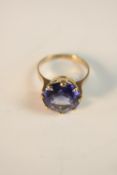 A 14 carat yellow gold and Iolite solitaire dress ring. Set to centre with a round mixed cut