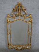 A 20th century Italian gilt framed framed wall hanging sectional mirror, mounted with urn and scroll