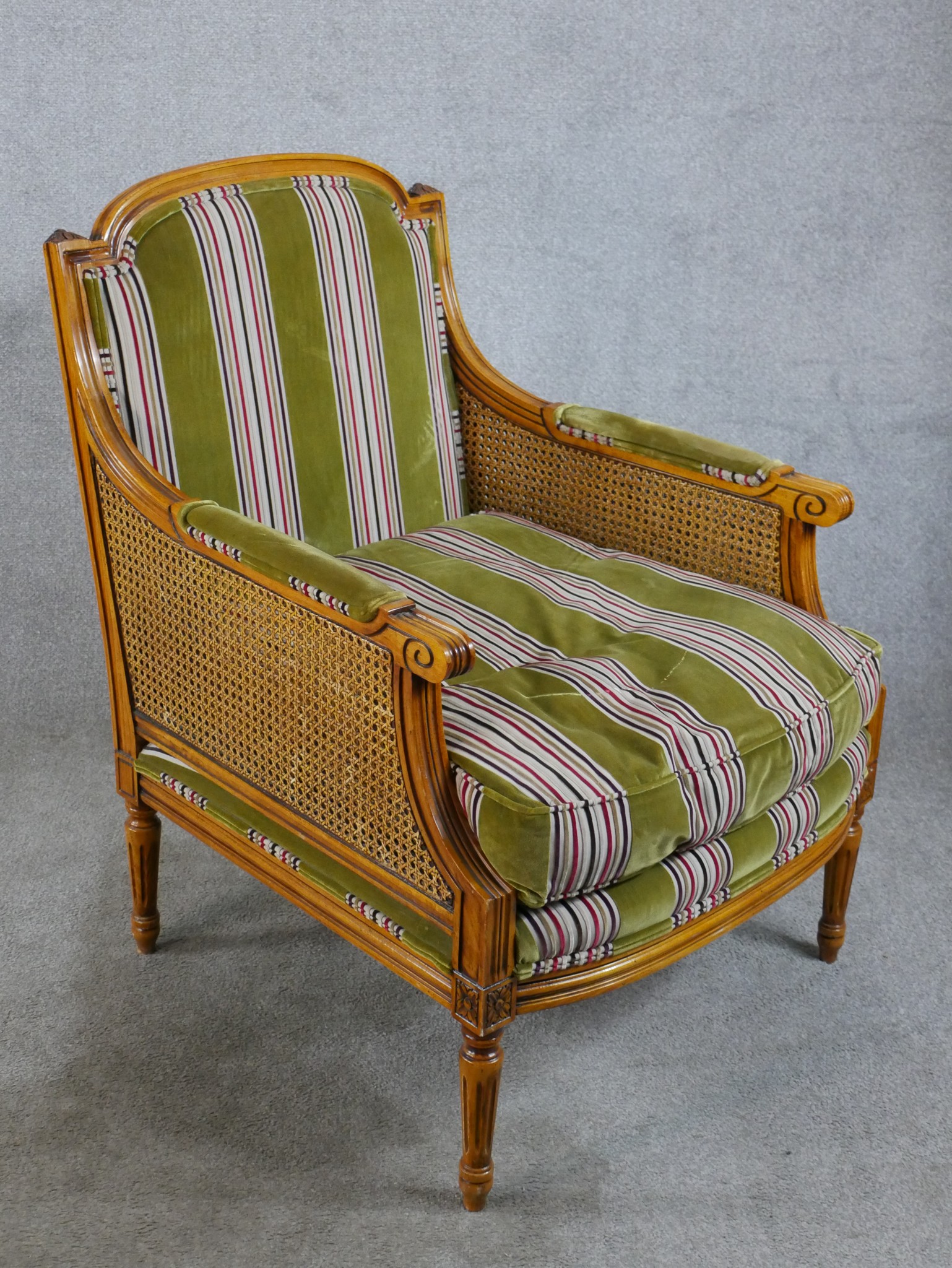 A late 19th/early 20th century walnut and bergère framed French style armchair raised on fluted - Image 4 of 5