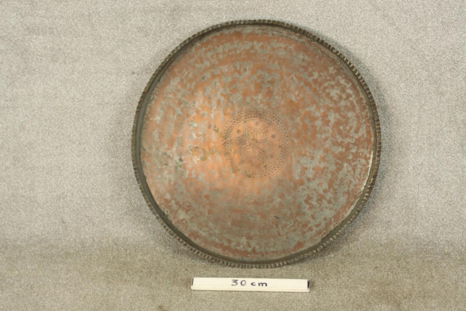 A late 19th/early 20th century engraved circular copper tray. Dia.65cm. - Image 2 of 5