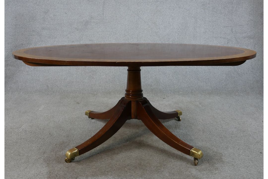 A Regency style inlaid mahogany oval coffee table raised on turned central column on four outswept - Image 2 of 6