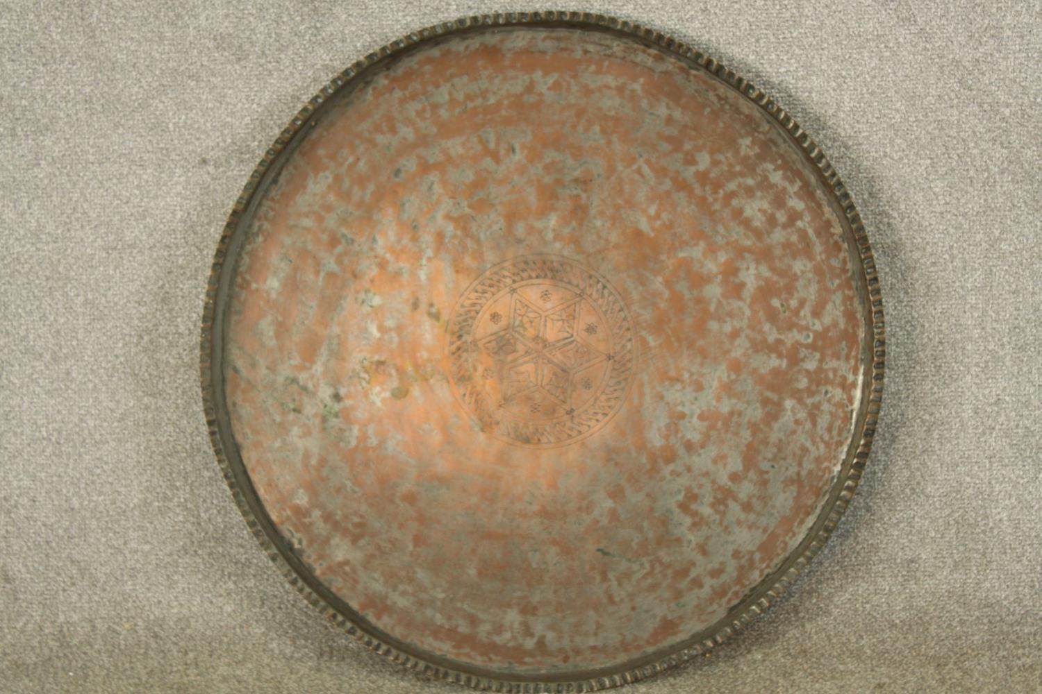 A late 19th/early 20th century engraved circular copper tray. Dia.65cm.
