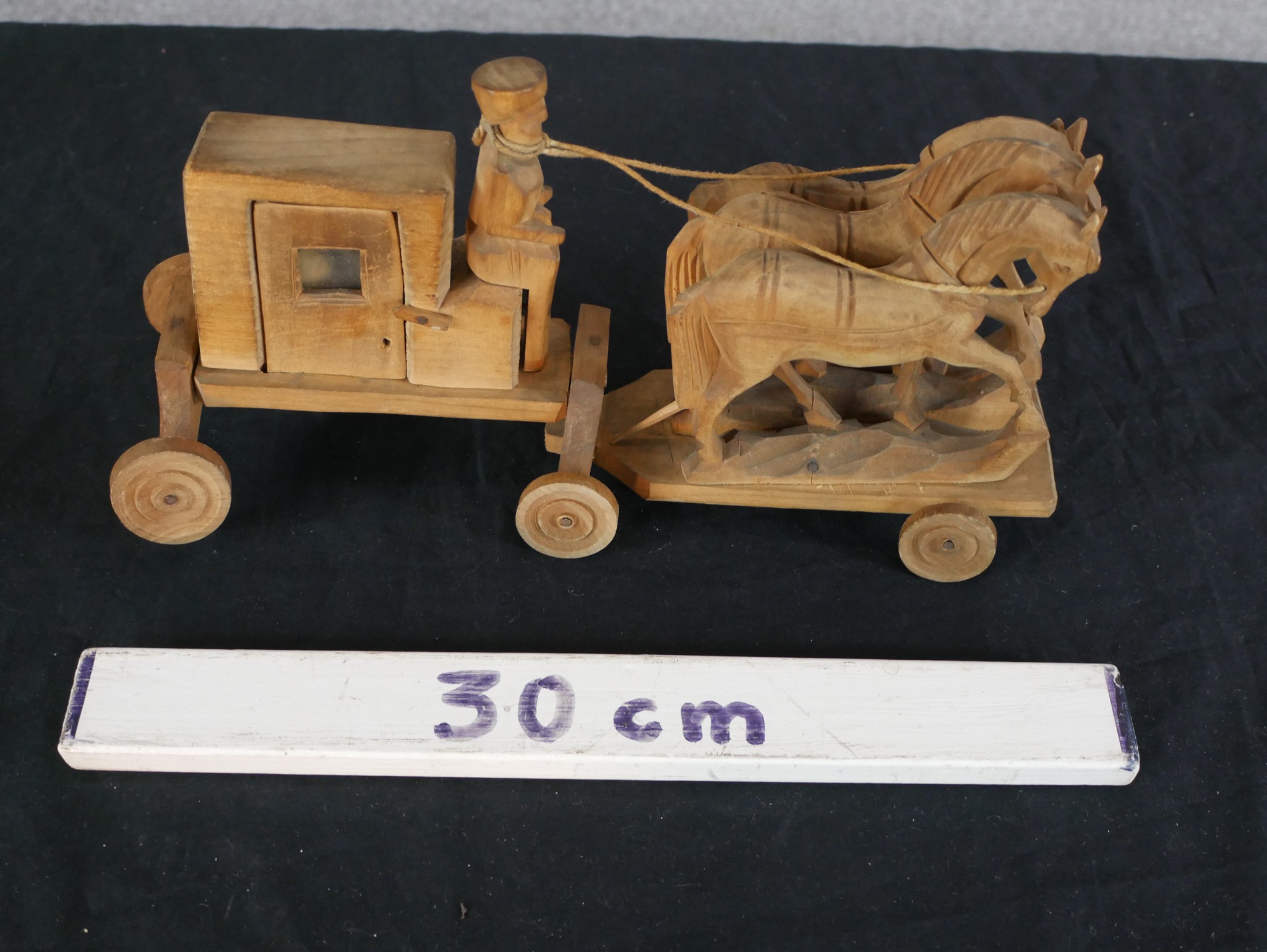A 20th century carved hardwood toy in the form of a horse being pulling a coach, raised on wheels. - Image 4 of 4