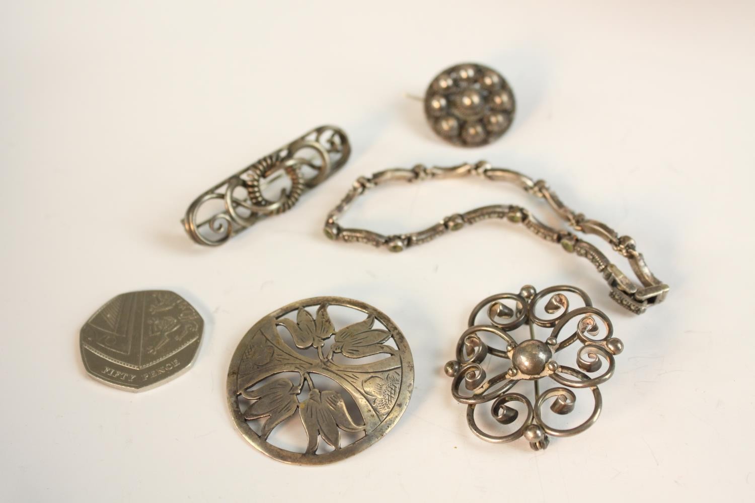 A collection of white metal and Danish silver brooches along with a peridot and marcasite set silver - Image 2 of 8