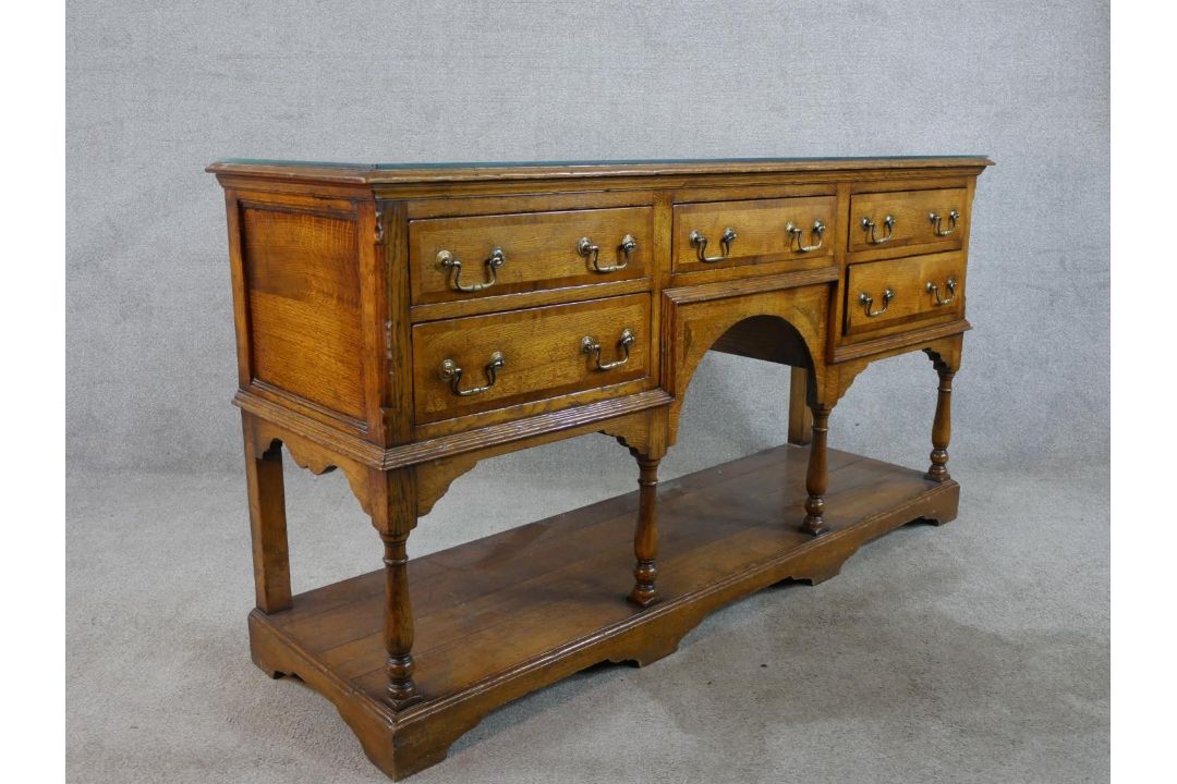 A 20th century oak five drawer sideboard with brass swing handles, raised on turned support with - Image 8 of 8