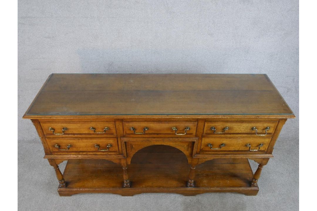 A 20th century oak five drawer sideboard with brass swing handles, raised on turned support with - Image 3 of 8