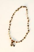 An early 20th century yellow metal (silver gilt) and Bohemian garnet set necklace with three petal