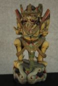 A 20th century carved and painted Balinese tribal figure. H.31 W.20 D.15cm.