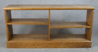 An early 20th century oak four shelf open bookcase raised on plinth base. H.71 W.147 D.33cm