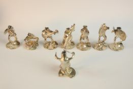 A set of eight place card holders modelled as an eight piece novelty silver frog orchestra by Mark