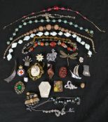 A collection of costume jewellery, including venetian foil necklaces, French paste jewellery and