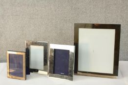 A pair of silver plated rectangular photograph frames, together with two other silver plated