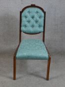 A 19th/early 20th century mahogany framed blue damask button back child's chair raised on sabre styl