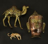 A collection of metal work items, a copper and brass Buddha head, a glass cabochon inlaid brass