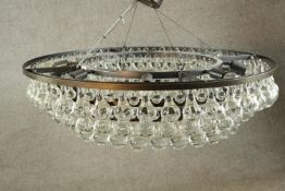 A contemporary Crystorama brass and glass tear drop four tier hanging chandelier. Dia.92cm.