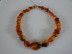 A large string of graduated amber beads, the largest bead measures 3.8cm. L.48cm.