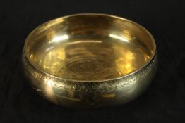 A 20th century Syrian circular brass bowl with engraved geometric pattern. Dia. 19cm.
