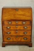A contemporary mahogany television/video stand formed as a George III bureau raised on shaped shaped