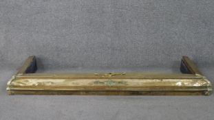 An Arts and crafts style brass fender with applied detailing. (Loose) H.11 W.120 D.39cm