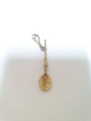 An Edwardian 9ct gold engraved charm in the form of a Welsh love spoon, the bale set with a