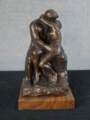 After Auguste Rodin (1840-1917, French) an Austin Sculpture of The Kiss, raised on square hardwood