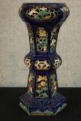 A 19th century Majolica tapering Gu shaped shaped floor standing pottery planter, raised on