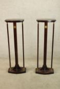A contemporary pair of Chinese hardwood and brass mounted jardinere stands raised on lozenge