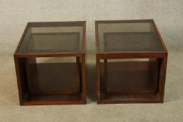 A pair of mahogany framed and smoked glass cube form occasional tables, together with a smaller