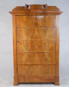 A Biedermeier figured walnut escritoire converted to a cabinet, the step down cornice over a door in
