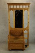 A contemporary stripped Keenpine mirror back hallstand with integral storage seat and umbrella/stick